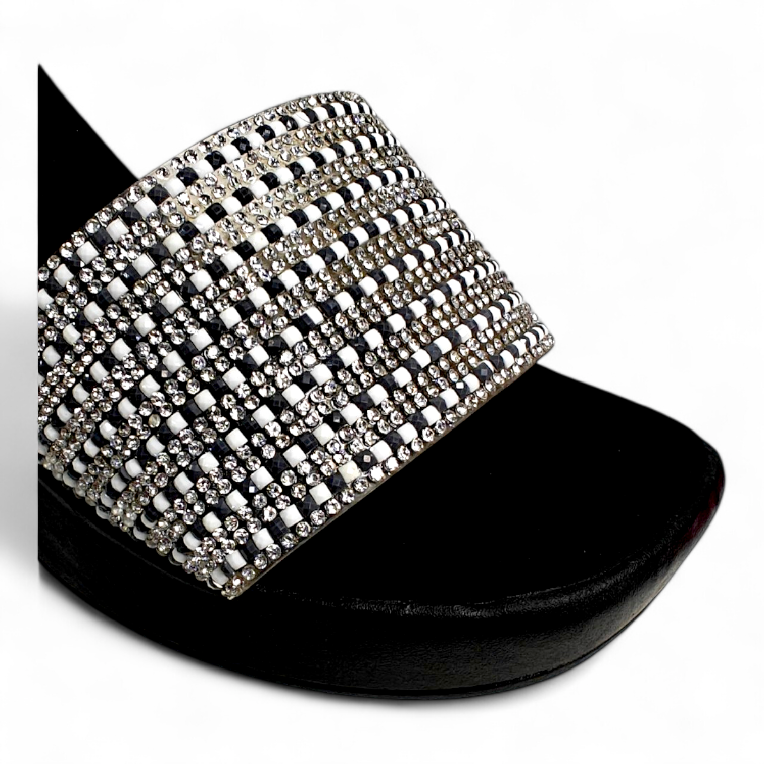 Close-up of embellished diamond belt on black big heel sandal showing luxury design